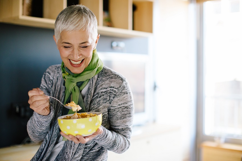 Mature woman having healthy breakfast to improve gut health